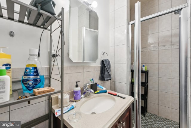 bathroom featuring vanity, walk in shower, and tasteful backsplash