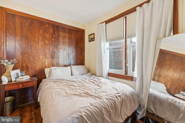 bedroom with dark hardwood / wood-style floors