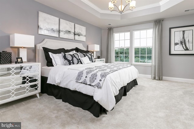 bedroom featuring light carpet, an inviting chandelier, a raised ceiling, and crown molding