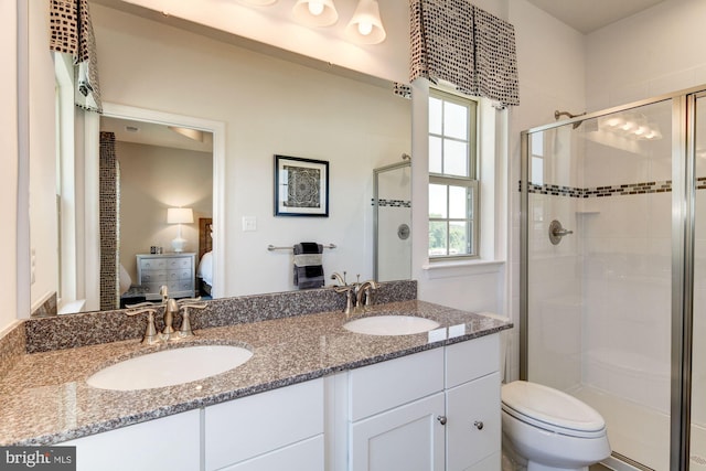 bathroom with vanity, toilet, and walk in shower