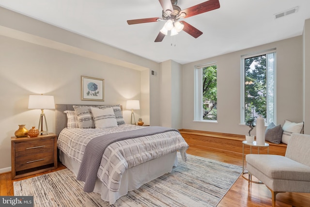 bedroom with hardwood / wood-style floors and ceiling fan