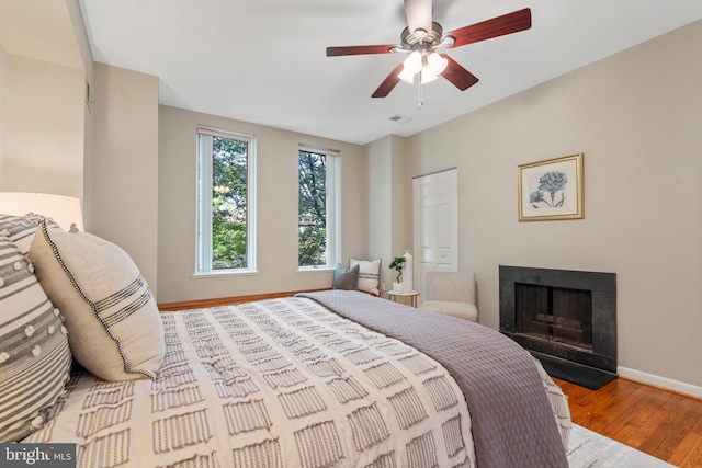 bedroom with light hardwood / wood-style floors and ceiling fan