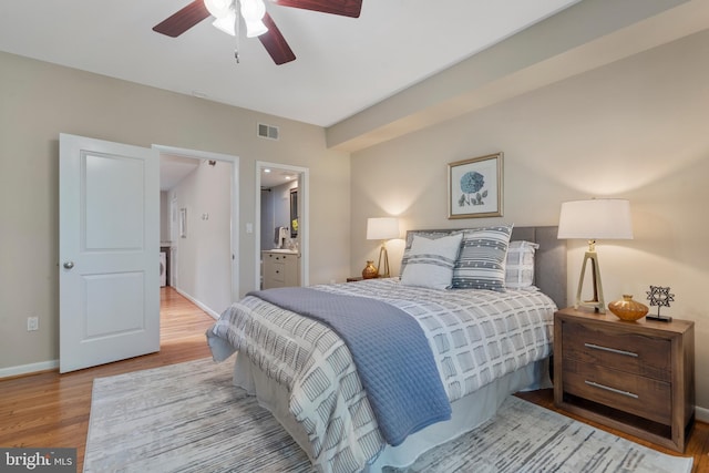 bedroom featuring ensuite bathroom, ceiling fan, and light hardwood / wood-style floors