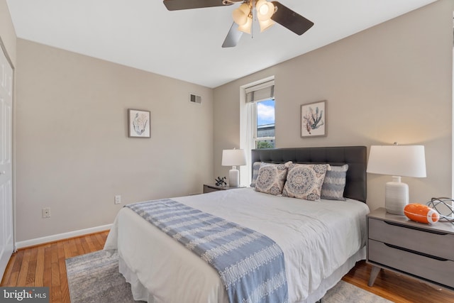 bedroom featuring ceiling fan, a closet, and light hardwood / wood-style flooring