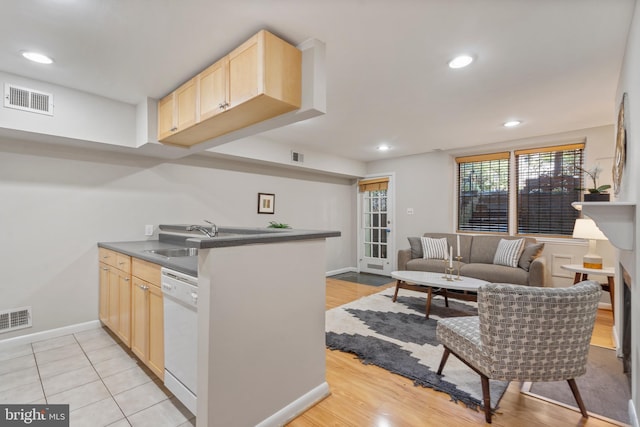 kitchen featuring dishwasher, light brown cabinets, kitchen peninsula, and sink