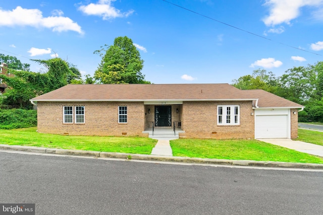 ranch-style home with a garage and a front lawn