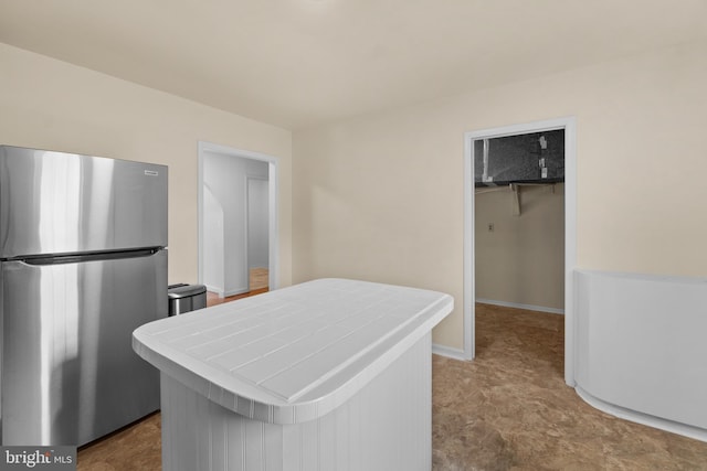 kitchen with stainless steel refrigerator and tile counters