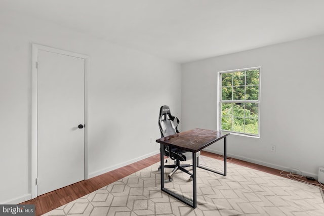 office area with light hardwood / wood-style floors