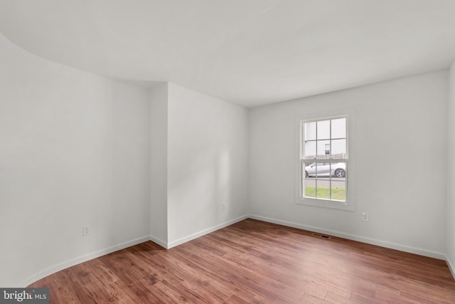 unfurnished room with light wood-type flooring