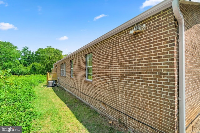 view of home's exterior featuring a yard and central air condition unit