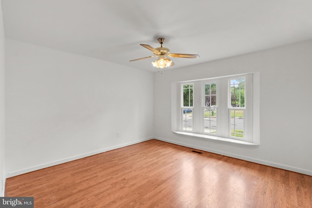 spare room featuring ceiling fan and light hardwood / wood-style flooring