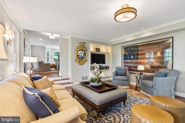 living area featuring visible vents, baseboards, ornamental molding, recessed lighting, and wood finished floors