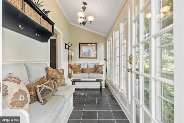 sunroom with a notable chandelier, a healthy amount of sunlight, and vaulted ceiling