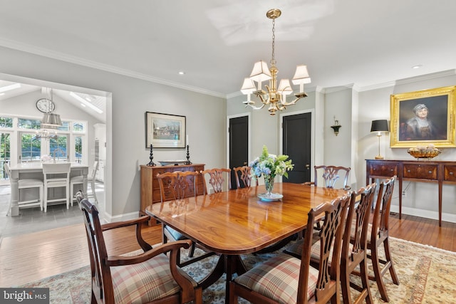 dining space featuring baseboards, a chandelier, ornamental molding, and hardwood / wood-style flooring