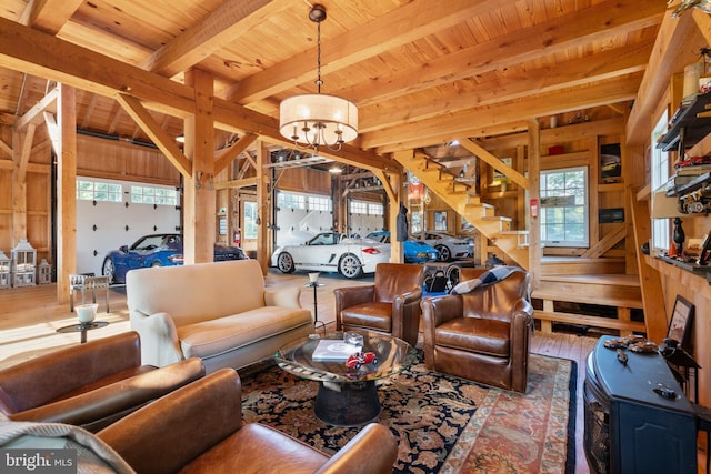 living area with beamed ceiling, wood ceiling, and an inviting chandelier