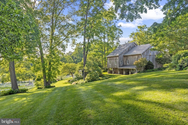 view of yard with a barn and fence