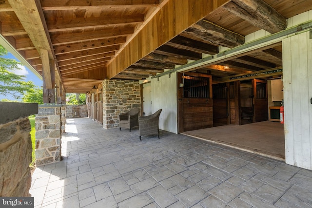 view of patio featuring an outbuilding and an exterior structure