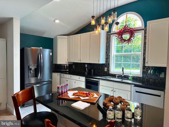 kitchen with white cabinets, beverage cooler, backsplash, and appliances with stainless steel finishes