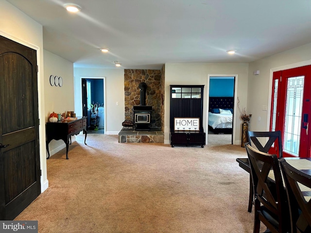 living room with a wood stove and carpet floors