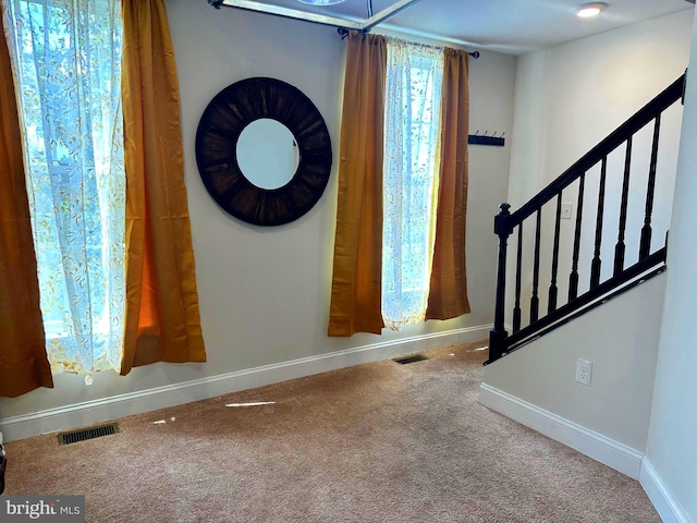 entrance foyer with carpet flooring