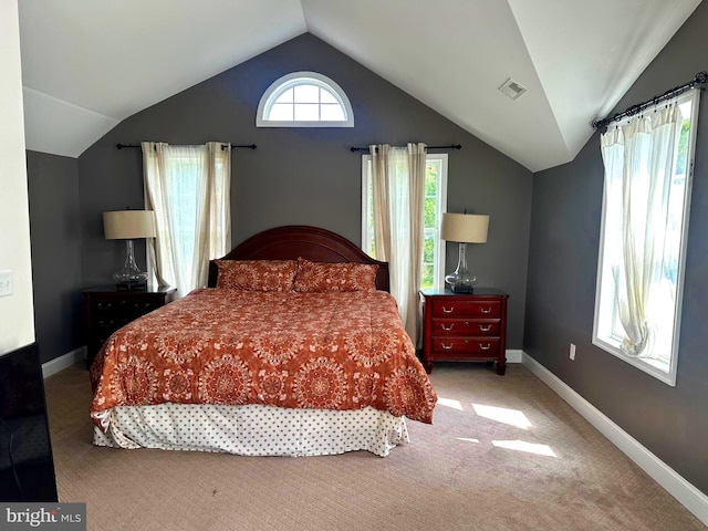 carpeted bedroom with vaulted ceiling