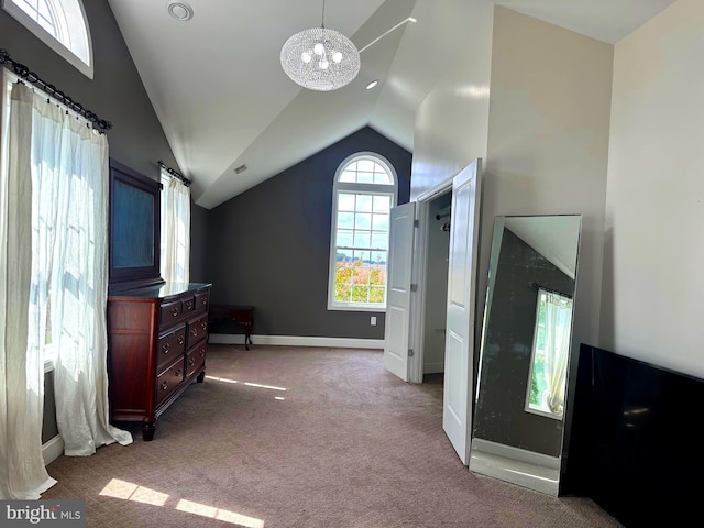 interior space featuring lofted ceiling and an inviting chandelier