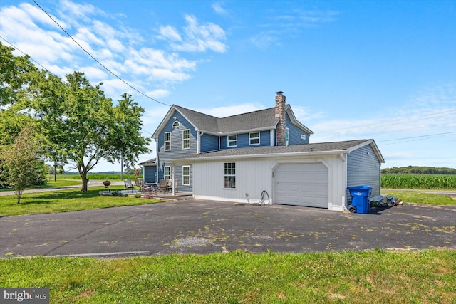 exterior space featuring a garage and a yard