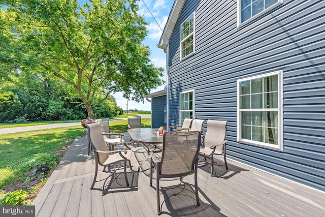 wooden terrace with a lawn