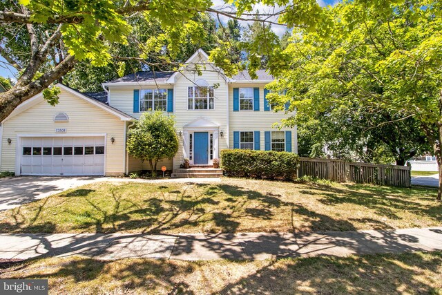 view of front of home with a garage and a front lawn