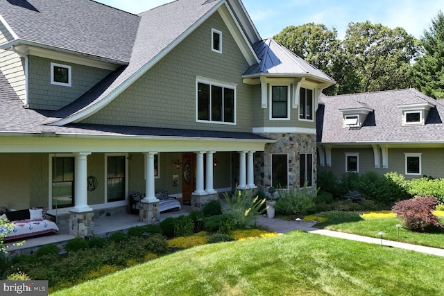 view of front of property with covered porch and a front yard