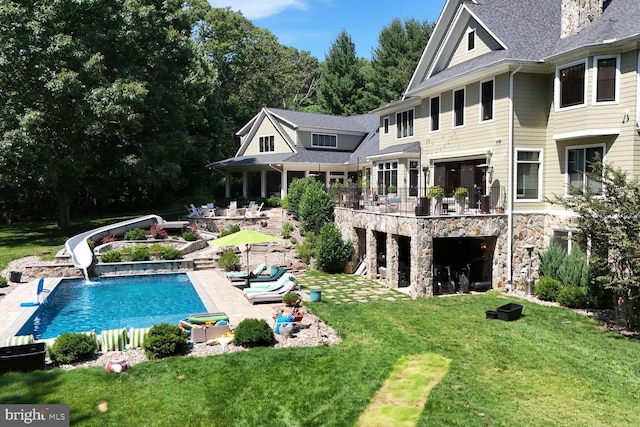 rear view of property featuring a yard and a patio area