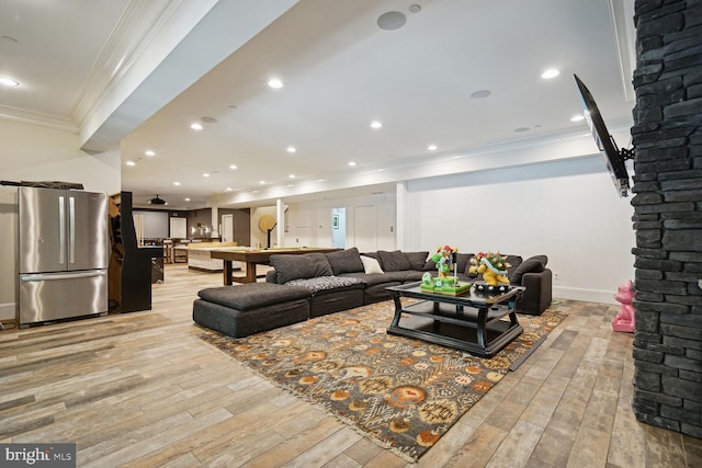 living room with light hardwood / wood-style floors and ornamental molding