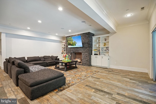 living room featuring light hardwood / wood-style floors, a stone fireplace, and ornamental molding