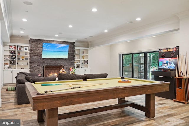 game room with a fireplace, light hardwood / wood-style flooring, built in features, and billiards