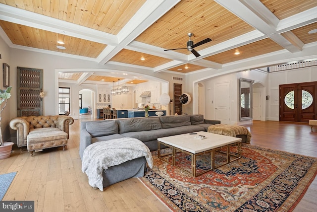 living room with beam ceiling, light hardwood / wood-style flooring, crown molding, and wooden ceiling