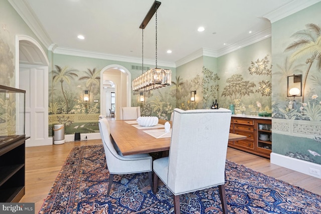 dining area featuring hardwood / wood-style flooring and ornamental molding