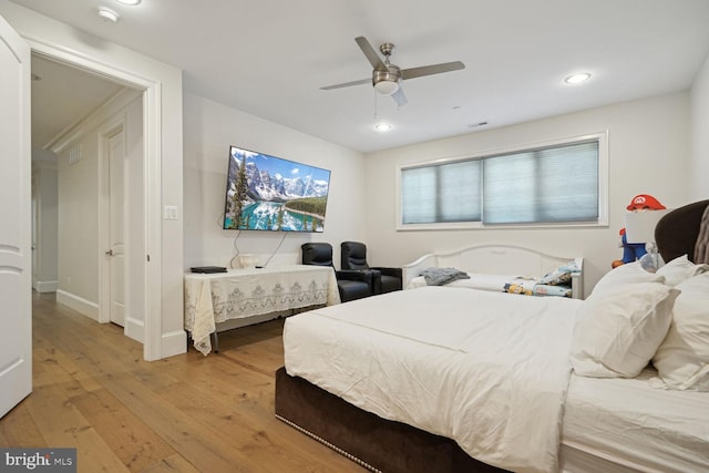 bedroom featuring ceiling fan and hardwood / wood-style flooring