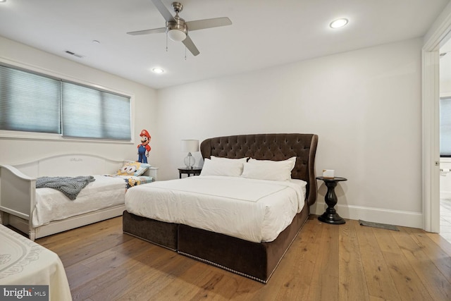 bedroom with ceiling fan and light hardwood / wood-style flooring