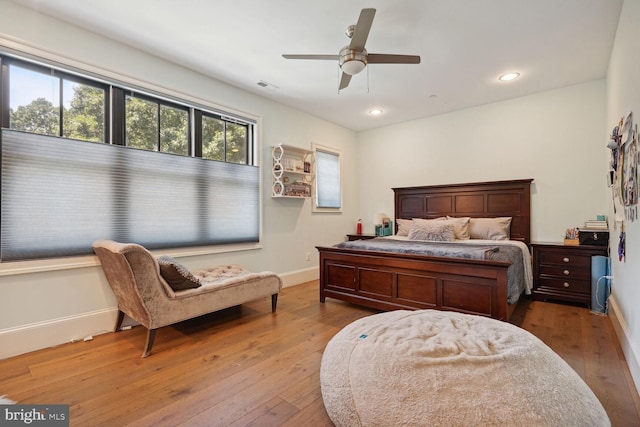 bedroom with ceiling fan and wood-type flooring