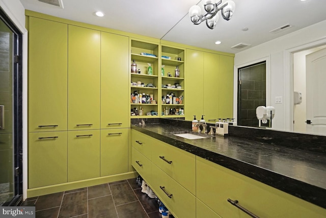 interior space featuring tile patterned flooring, vanity, and an inviting chandelier