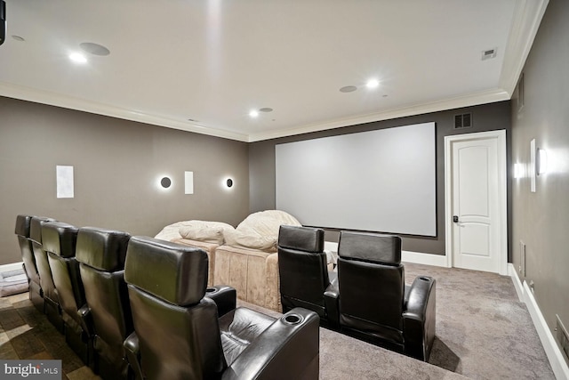 carpeted cinema room featuring crown molding