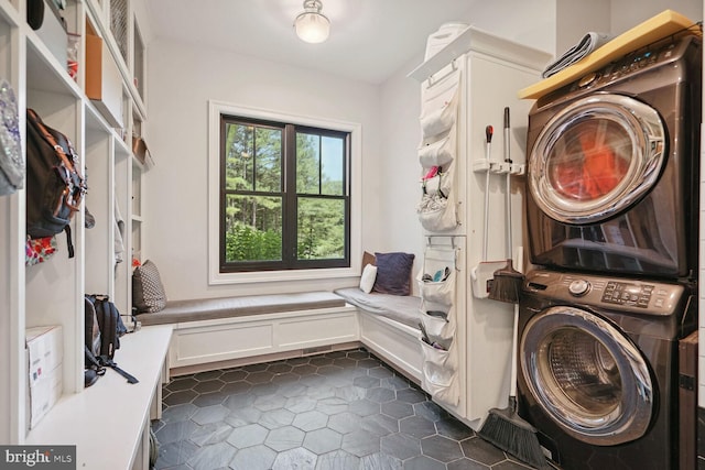 washroom featuring stacked washing maching and dryer