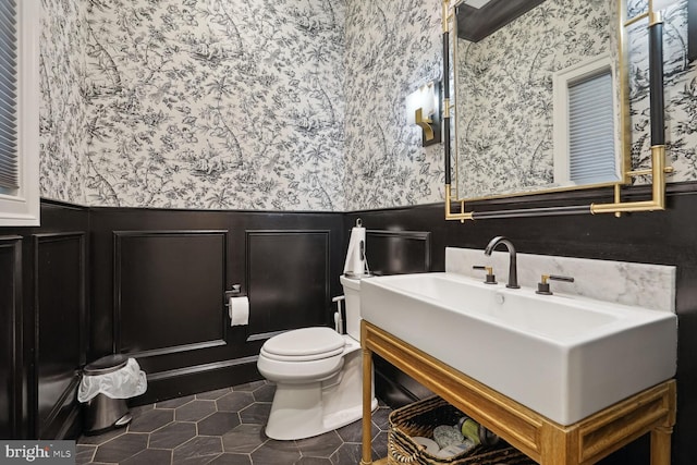 bathroom with tile patterned flooring, vanity, and toilet