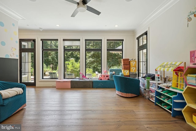 sunroom featuring ceiling fan