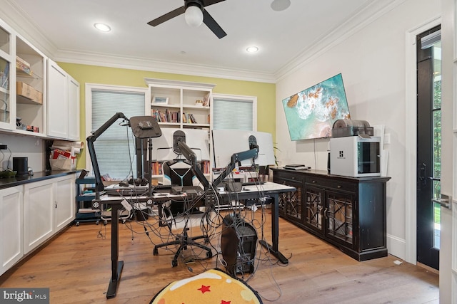 miscellaneous room featuring ceiling fan, light wood-type flooring, and crown molding