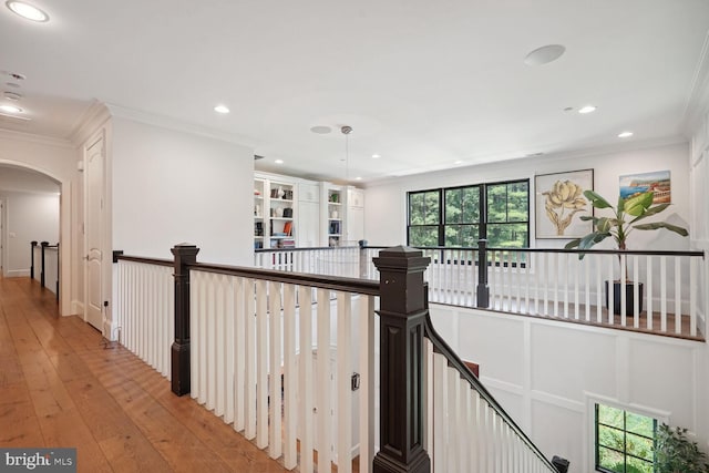 corridor featuring light hardwood / wood-style flooring and ornamental molding