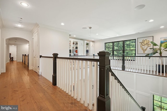 hall featuring light wood-type flooring and ornamental molding