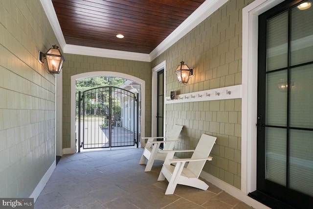 exterior space with tile walls, ornamental molding, and wood ceiling