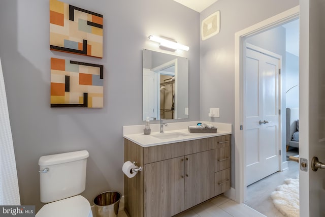 bathroom with toilet and vanity