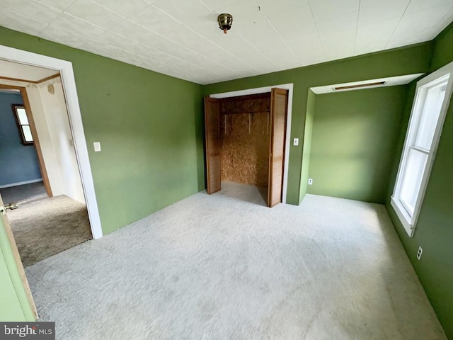 unfurnished bedroom featuring a closet and carpet